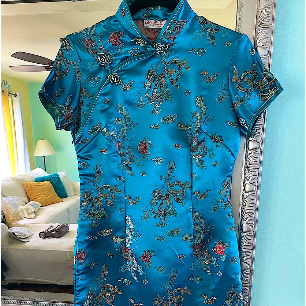 Brilliant turquoise cocktail dress. Embroidered frog closures at neck